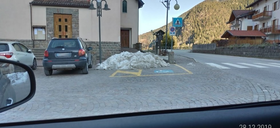 Una montagna di neve sul parcheggio riservato ai disabili: succede a Brusago ma purtroppo è un'abitudine diffusa